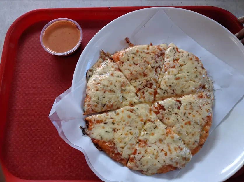 ND's pizza - and the sauce that has no business being this good.